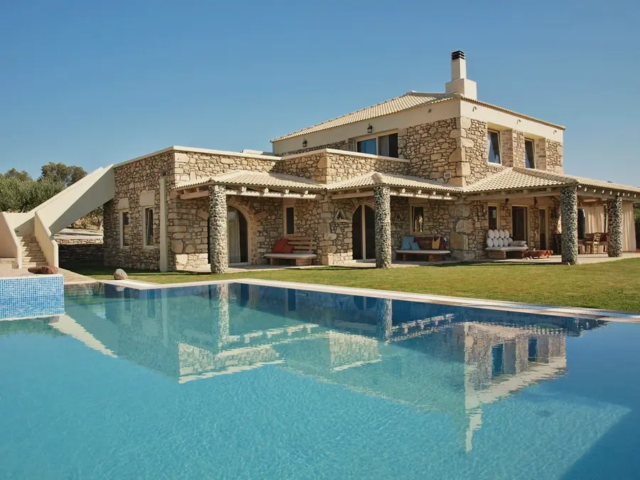 A stone farmhouse with a pool