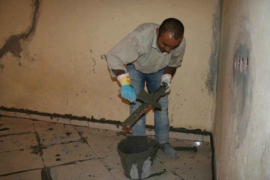 Tiles being laid by hand